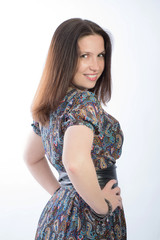 beautiful woman with a brown hair standing in a half turn