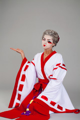 Beautiful young woman in white kimono