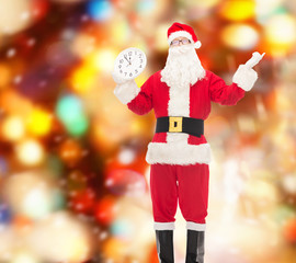 man in costume of santa claus with clock