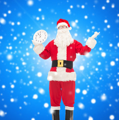 man in costume of santa claus with clock