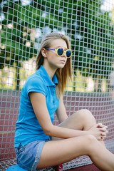 beautiful girl sitting on a skateboard