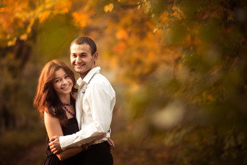 Beautiful embrace couple in the autumn park