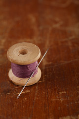 real old reels spoon treads with needle and thimble on old woode