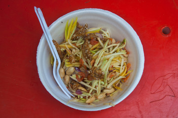 Spicy mango salad with fried vegetables