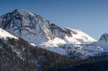 Fototapeta premium snow mountain peak with sunlight, colorado 