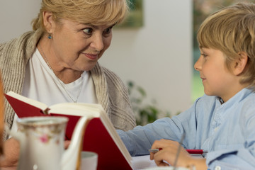 Senior babysitter caring about schoolboy