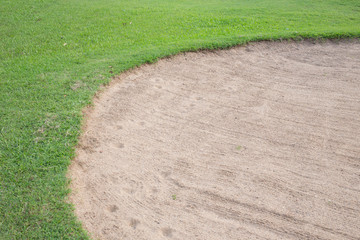 sand bunker and green grass of golf course