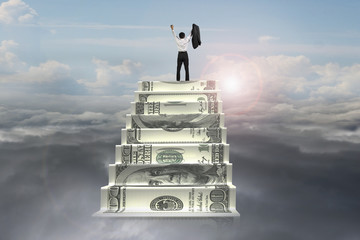 businessman cheer on top of money stairs with sunlight cloudscap