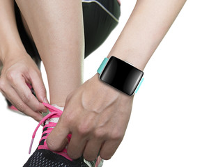 woman hand tying shoelaces wearing smartwatch with bright green