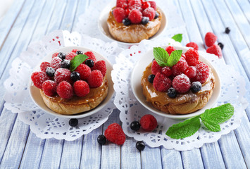 Sweet cakes with berries on table close-up