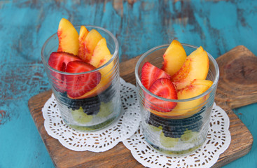 fresh tasty fruit salad on blue wooden table