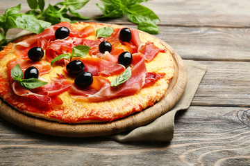 Delicious pizza served on wooden table