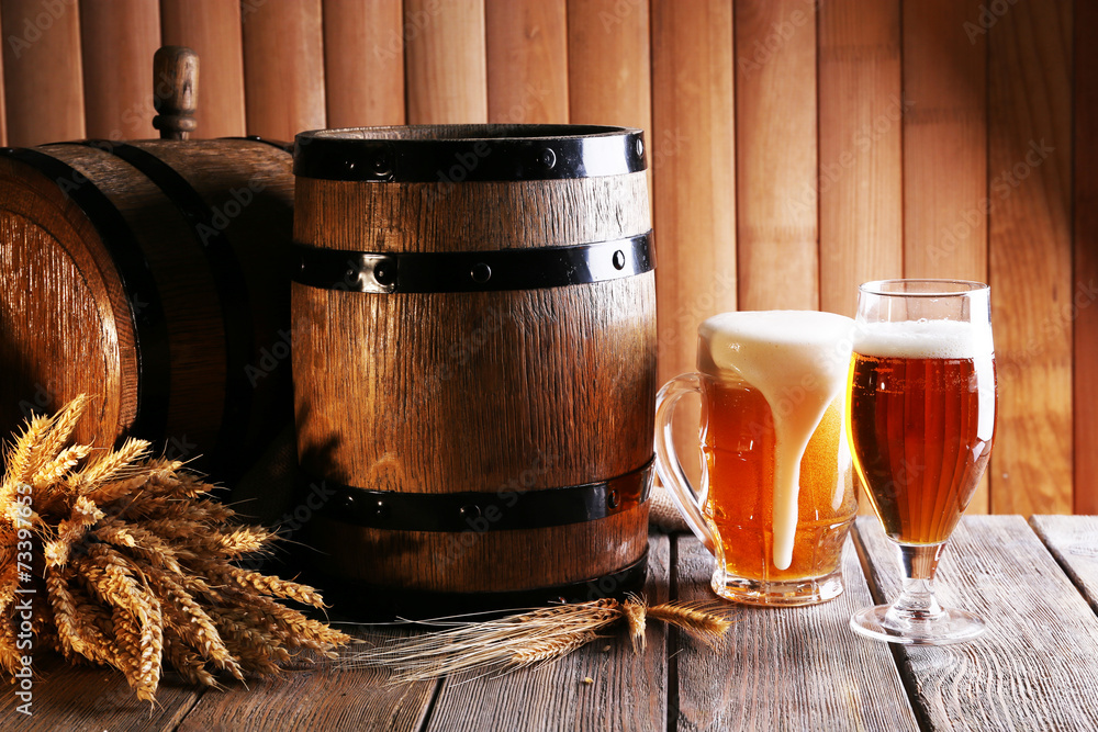 Wall mural beer barrel with beer glasses on table on wooden background