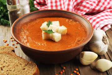 Delicious lentil cream-soup on table close-up