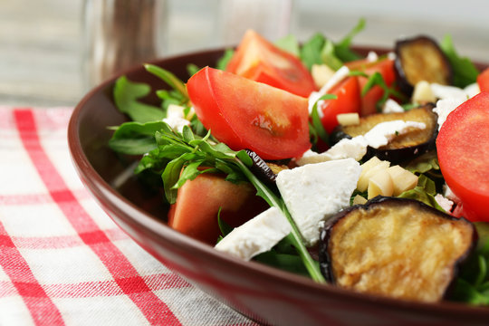 Eggplant salad with tomatoes, arugula and feta cheese,