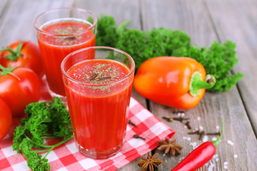 Tomato juice in glasses and fresh vegetables