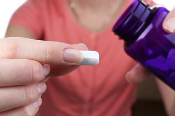 Pill in hand, close-up