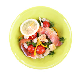 Appetizing fish salad with vegetables on plate isolated on
