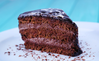 Delicious chocolate cake on plate on table close-up