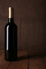 Bottle of red wine on dark background