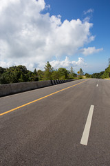 asphalt roadway with cloud blue sky background