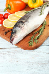 Fresh raw fish and food ingredients on table