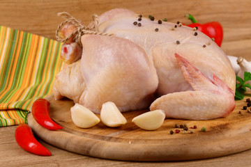 Raw chicken on wooden table