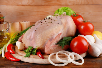 Raw chicken on wooden table