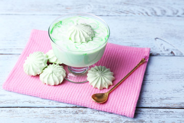 Mint milk dessert in glass bowl on color wooden background