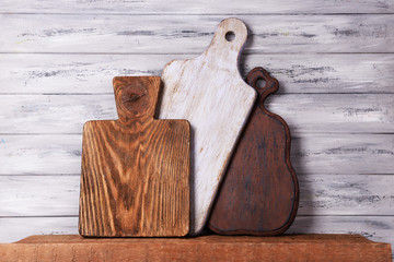 Empty cutting boards on wooden background