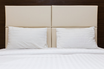 Fototapeta na wymiar bedroom with white pillow and leather headboard