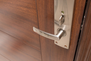metal door handle on wooden door