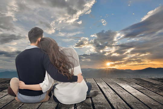 Asian Young Couple Sit And Hug Together