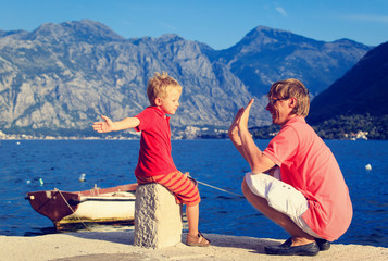 father and son playing on sea vacation