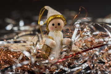 Small wooden Santa carries gift