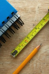 Notebook, tape measure and a pencil