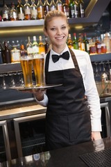 Pretty waitress holding a tray of champagne