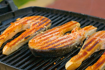 Portion of fresh salmon fillet cooced on a grill