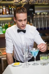 Bartender preparing a drink at bar counter