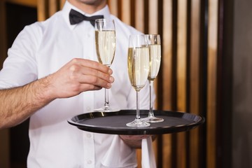 Waiter holding tray of champagne