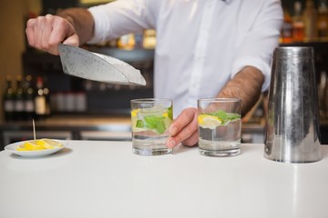 Happy bartender making a cocktail