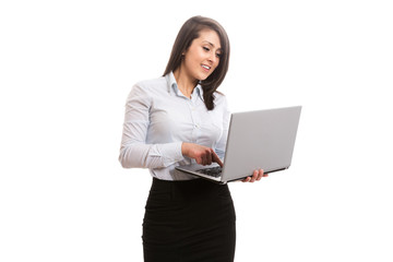Attractive office worker holding and looking at laptop screen