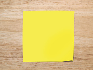 yellow paper note on Texture of wood background closeup