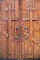 Closeup of old wooden doors with orthodox crosses