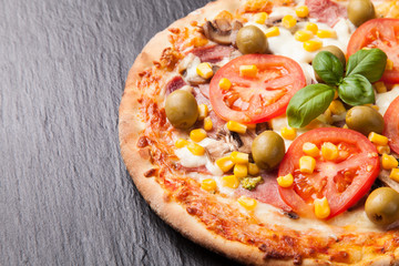 Delicious fresh pizza served on black stone