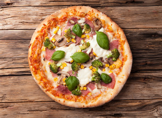 Delicious fresh pizza served on wooden table