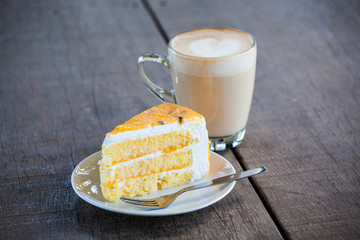 Cake with cup of coffee on old wood table