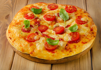 Pizza with cheese, basil and tomatoes