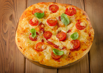 Homemade  pizza with cheese,basil and tomatoes