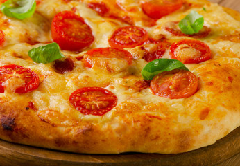 Homemade  pizza with cheese, basil and tomatoes